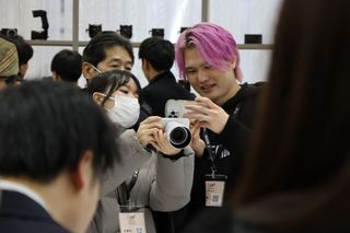 People surrounding the Sigma stand at the CP+ 2025 photography show, getting hands on the BF camera