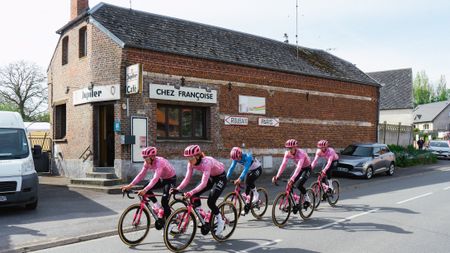 A group of riders go past the Chez Fran&ccedil;oise bar in Troisvilles