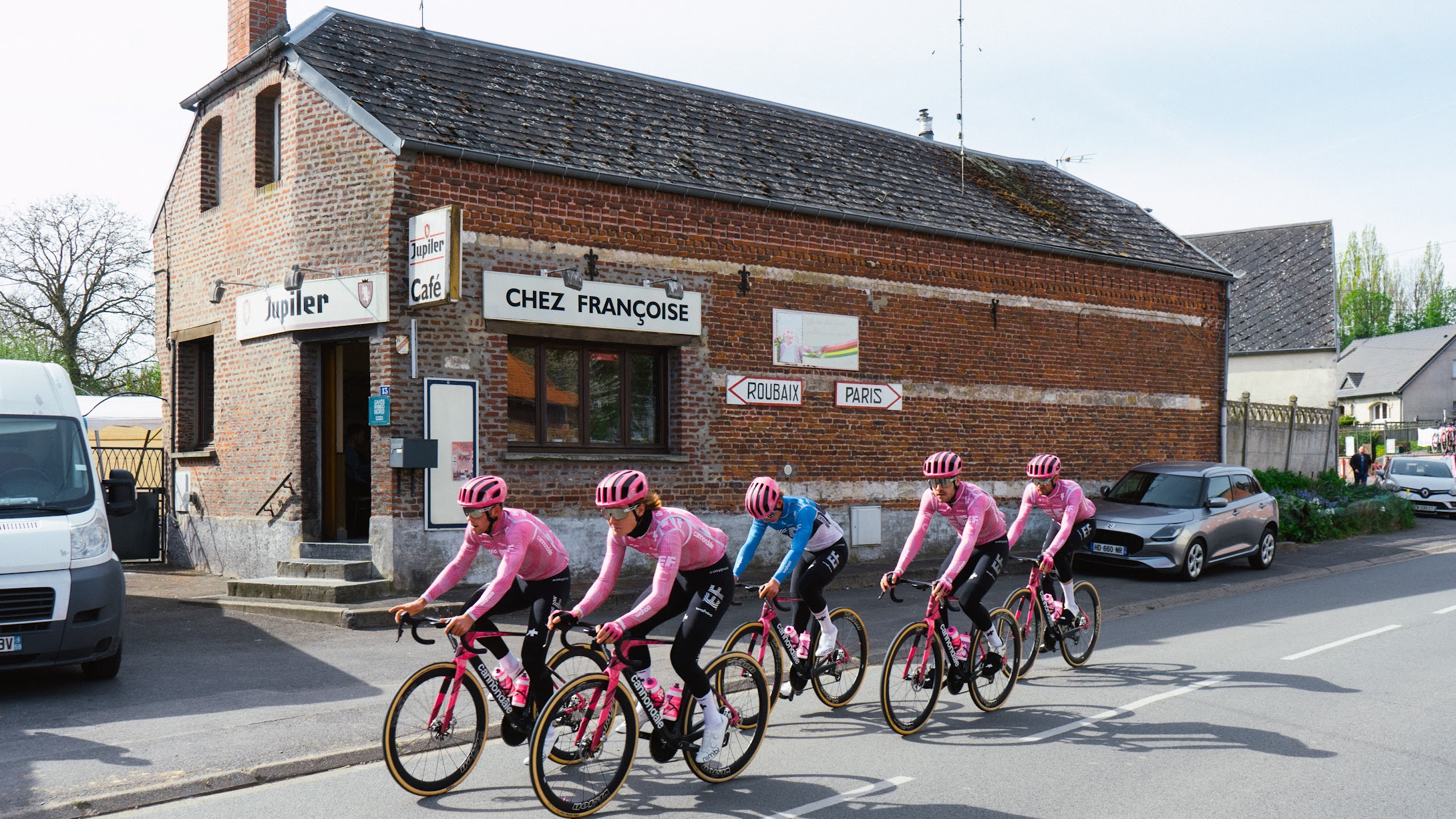 A group of riders go past the Chez Fran&ccedil;oise bar in Troisvilles