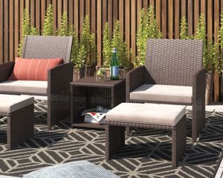 Latitude Run® Wicker 2 - Person Seating Group in brown wicker on patio by fence on top of rug