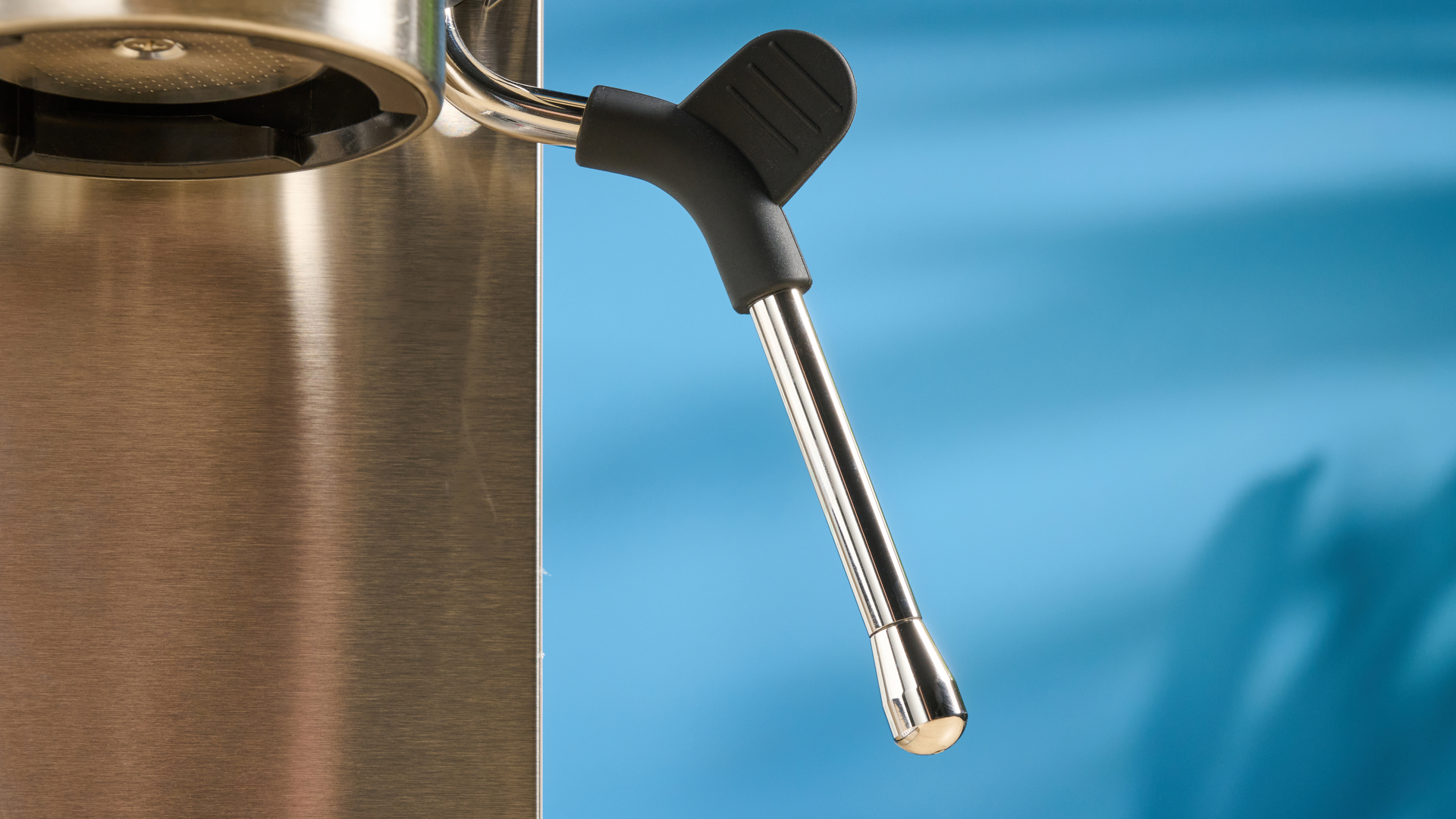 the casabrews cm5418 espresso machine in silver showing its steam wand and water tank and accessories