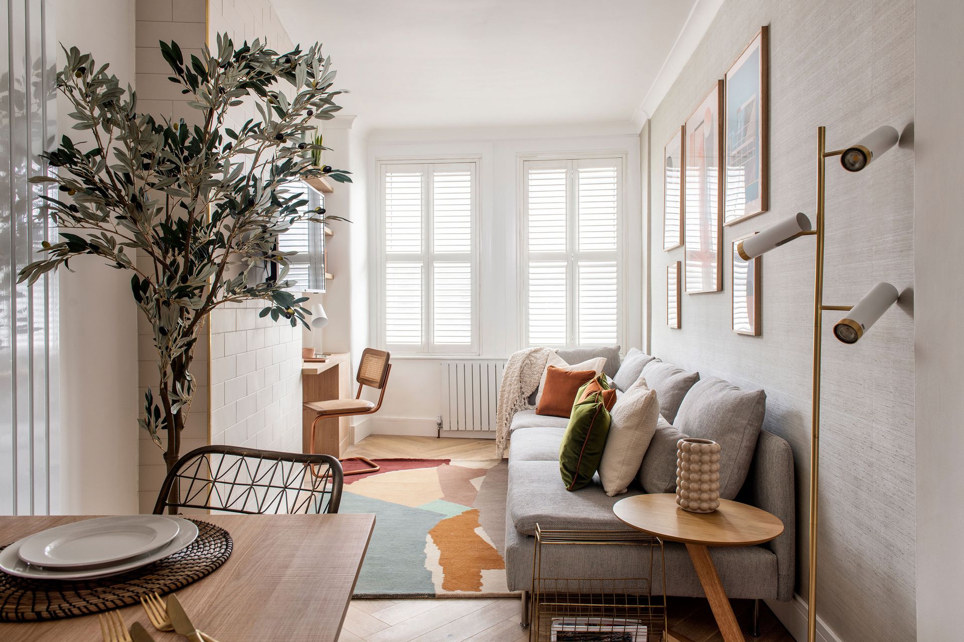 a small living room with a colorful rug