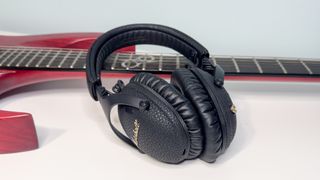 Marshall Monitor III headphones on a guitar neck