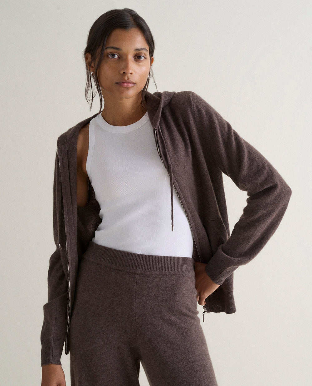 a model wearing a brown cashmere zip-up hoodie