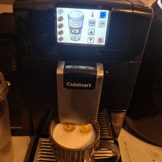 Cuisinart Veloce coffee machine with latte in a coffee mug