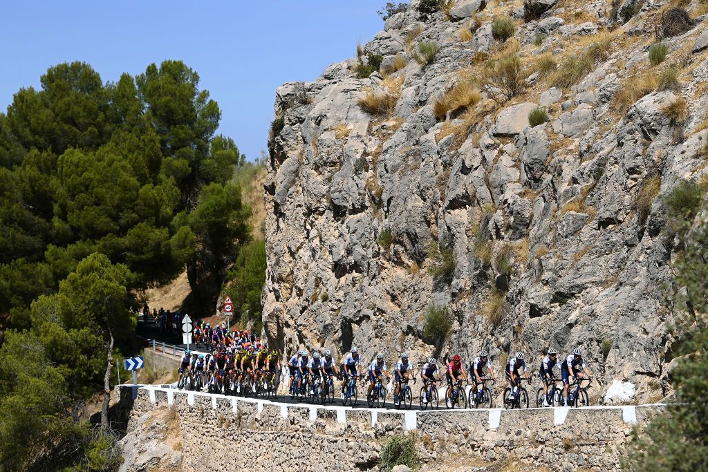 SIERRA DE LA PANDERA SPAIN SEPTEMBER 03 Rmi Cavagna of France Dries Devenyns of Belgium Remco Evenepoel of Belgium and Team QuickStep Alpha Vinyl Red Leader Jersey with teammates lead the peloton passing through the Puerto de Las Siete Pilillas 937m during the 77th Tour of Spain 2022 Stage 14 a 1603km stage from Montoro to Sierra de La Pandera 1815m LaVuelta22 WorldTour on September 03 2022 in Sierra de La Pandera Spain Photo by Tim de WaeleGetty Images