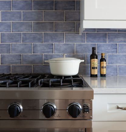 Stove grates with blue tile backsplash