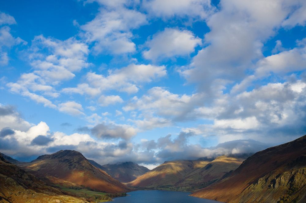 An aerial view of a lake running through a valley