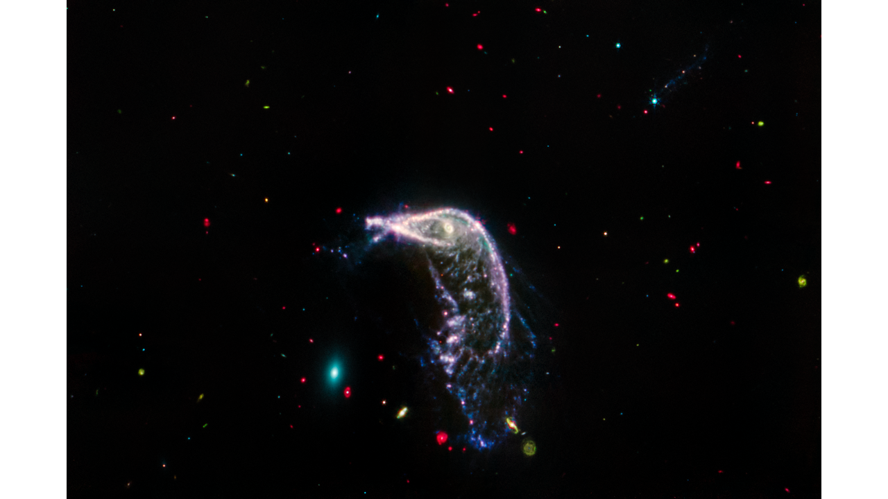 NASA Space Technology Red, blue, and yellow speckles dot the background of space. The Penguin and Egg galaxy are seen in the middle, with a different color scheme than the header.