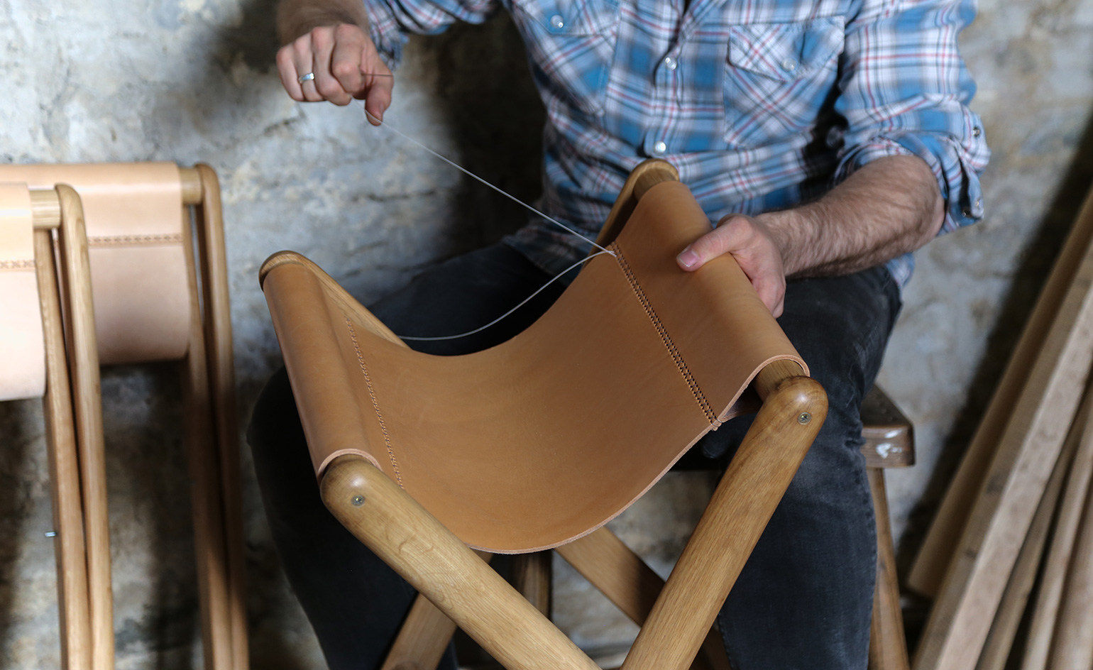 A man is weaving the folding chair