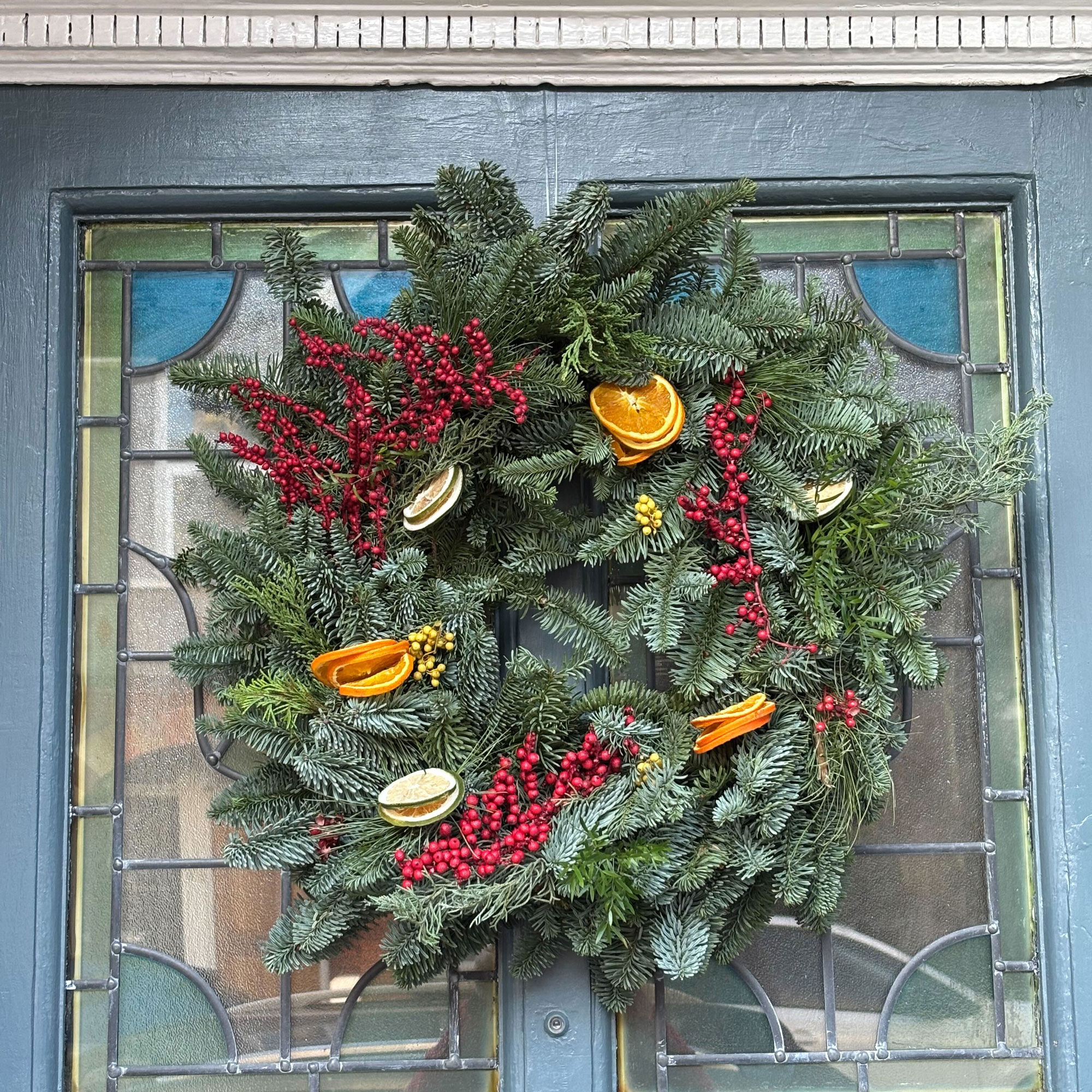 Blue front door with green wreath
