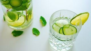 Two glasses of cucumber water on a table