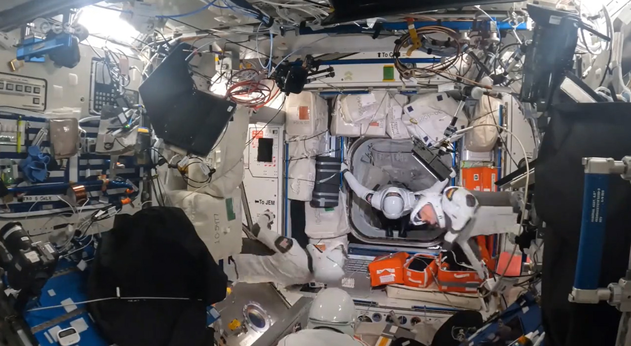 SpaceX Crew-3 astronauts float in weightlessness in SpaceX spacesuits.