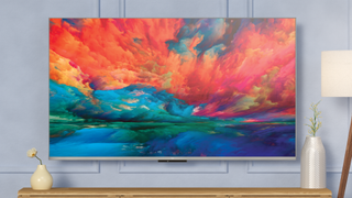 Fire TV Omni QLED on wall showing art