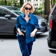 Saoirse Ronan wears a blue button-down shirt and blue trousers