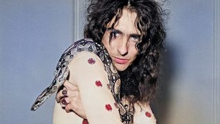 American rock singer Alice Cooper poses with his snake in London on his Love It To Death Tour.12th November 1971. 