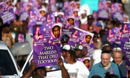 Demonstrators march to commemorate the death of Trayvon Martin