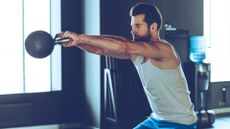 A man doing kettlebell swings