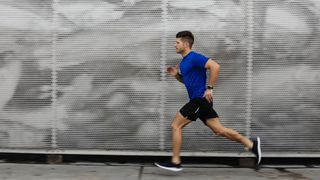 A man runs along a sidewalk