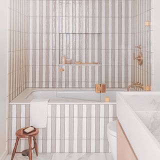 Tiled pink and white bath and wall in bathroom