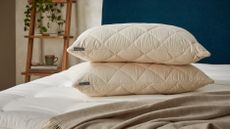 Woolroom Deluxe Washable Wool Pillows on a bed