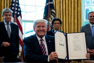 WASHINGTON, DC - APRIL 24 U.S. President Donald Trump participates in a signing ceremony for H.R.266, the Paycheck Protection Program and Health Care Enhancement Act, with members of his administration and Republican law