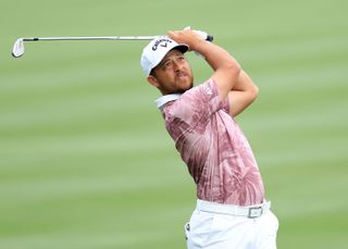 Xander Schauffele watches his wedge shot