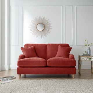 An apricot coloured sofa in a neutral room