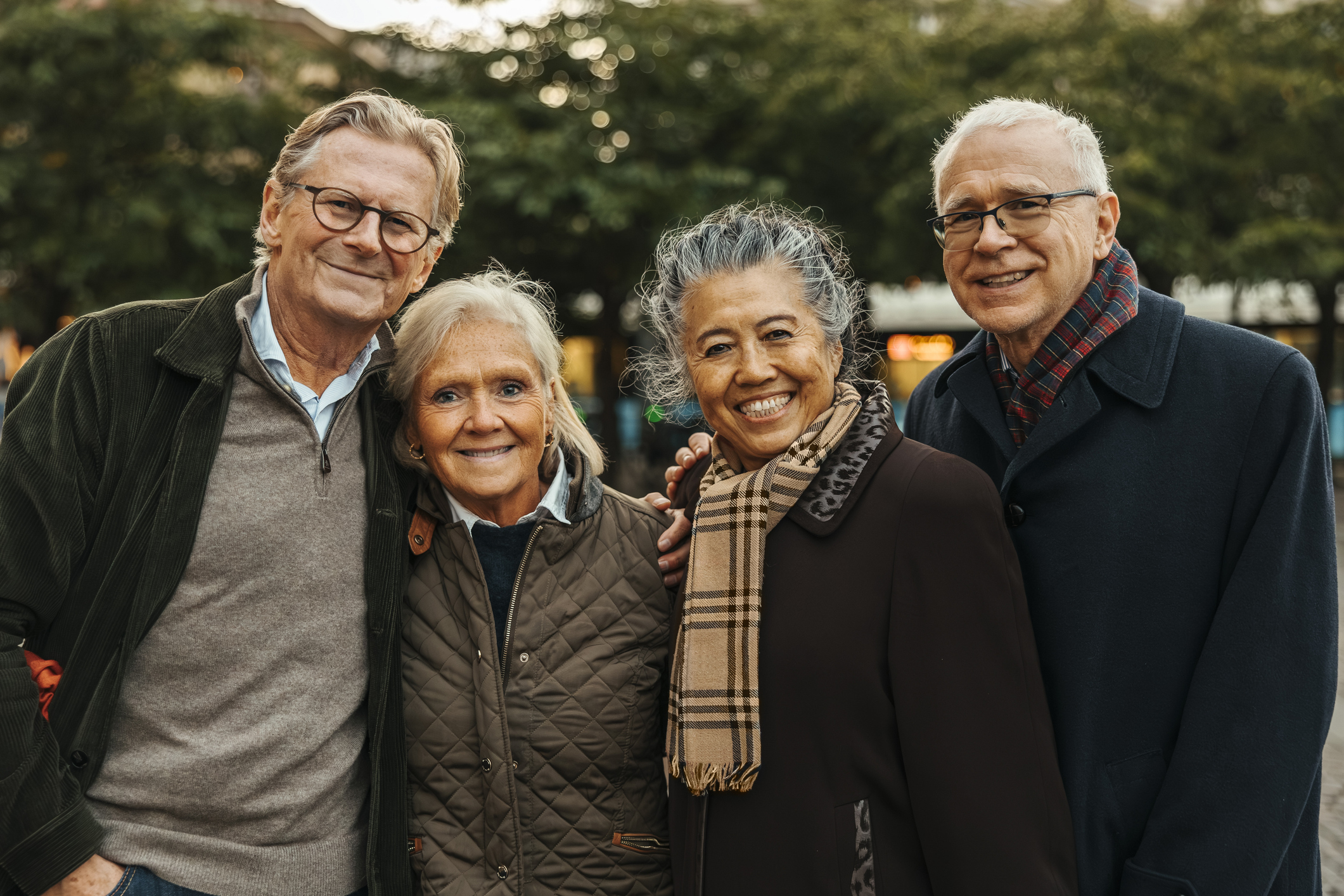 Two older couples standing outside in a midwest location.
