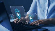 woman typing on laptop with security symbols superimposed