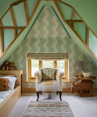 green painted and wallpapered attic kids bedroom with fitted bed and antique furniture pieces