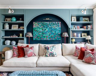 Family room with blue fitted cabinets and arch