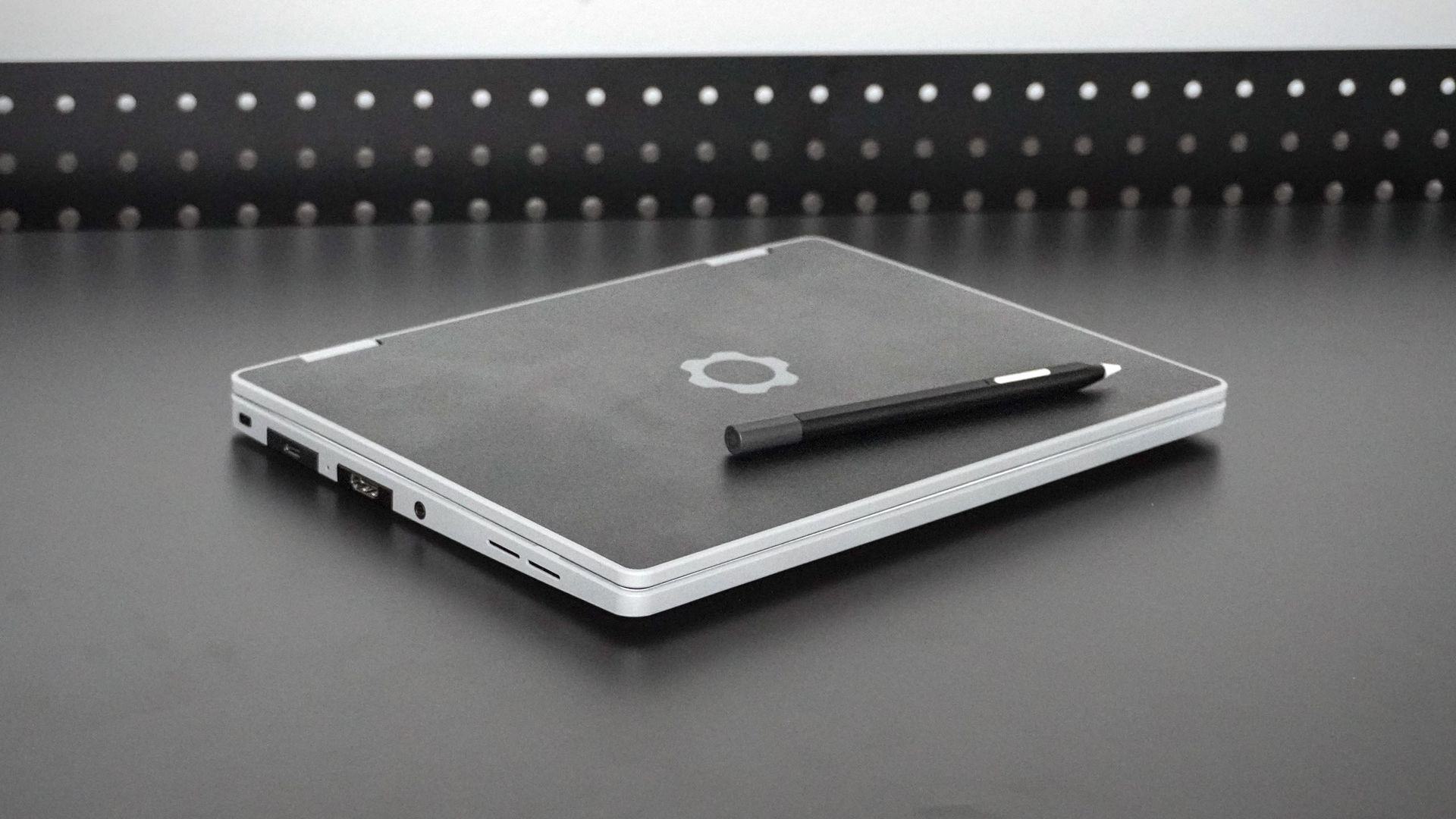 The Framework Laptop 12 with matching stylus lying closed on a desk