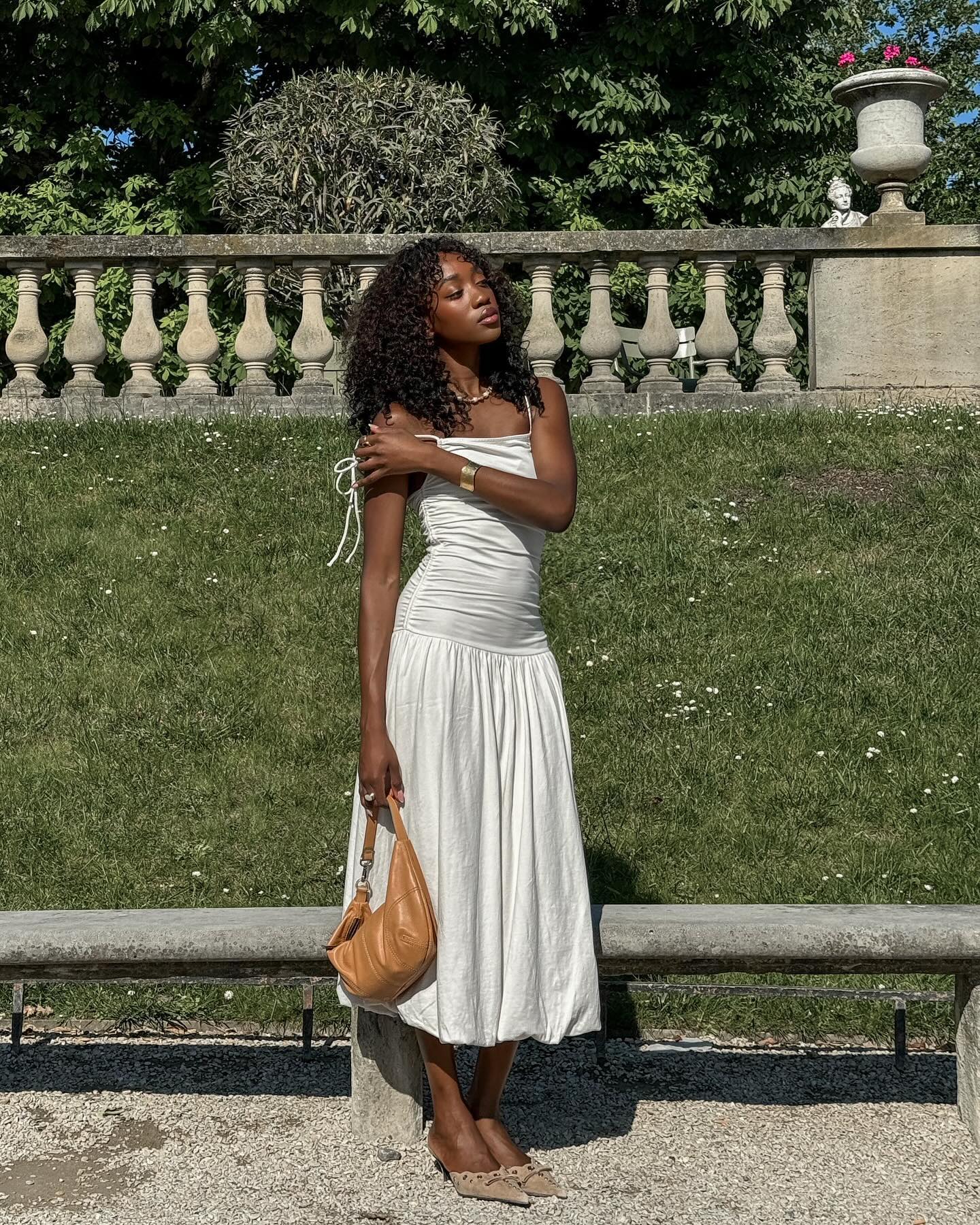 Woman wearing drop-waist white dress
