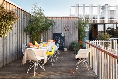 eames plastic chairs on decking from vitra