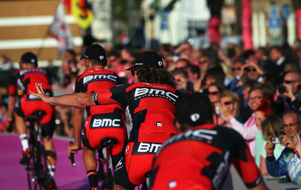 A BMC rider waves to the crowd from the platform leading to the main stage in Apeldoorn.