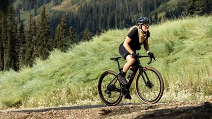 A woman cyclist riding the new Liv Devote Advanced Pro gravel bike 