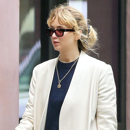 jennifer lawrence wears her leopard prada bag with a white coat