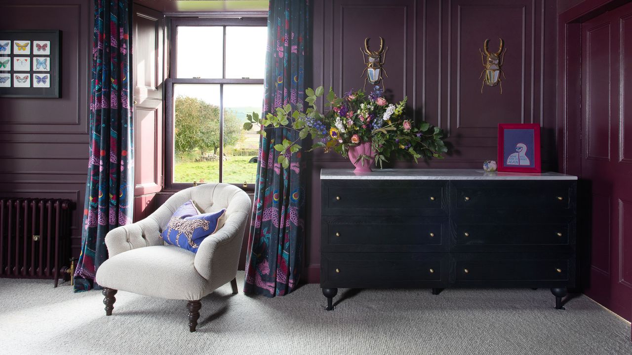 Purple room with grey carpet and black sideboard