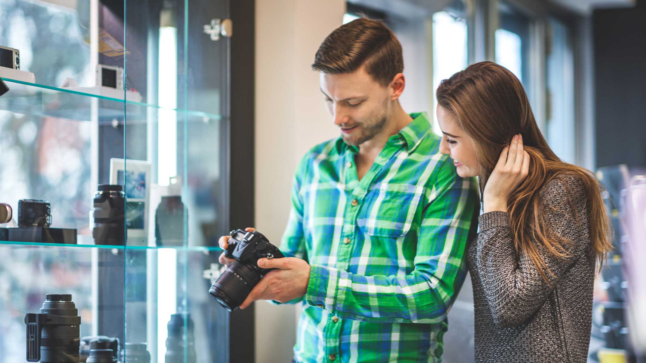 Couple in a camera store with camera in-hand