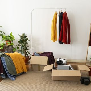 boxes of clothes and clothes on hanging rail