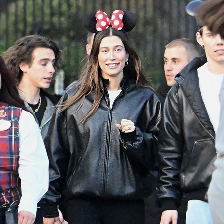 Justin Bieber, Hailey Bieber, and The Kid LAROI enjoy an evening at Disneyland. The group donned Mickey ears and were accompanied by four bodyguards as they made their way through the park, enjoying many of the thrill rides, including Space Mountain and Pirates of the Caribbean.