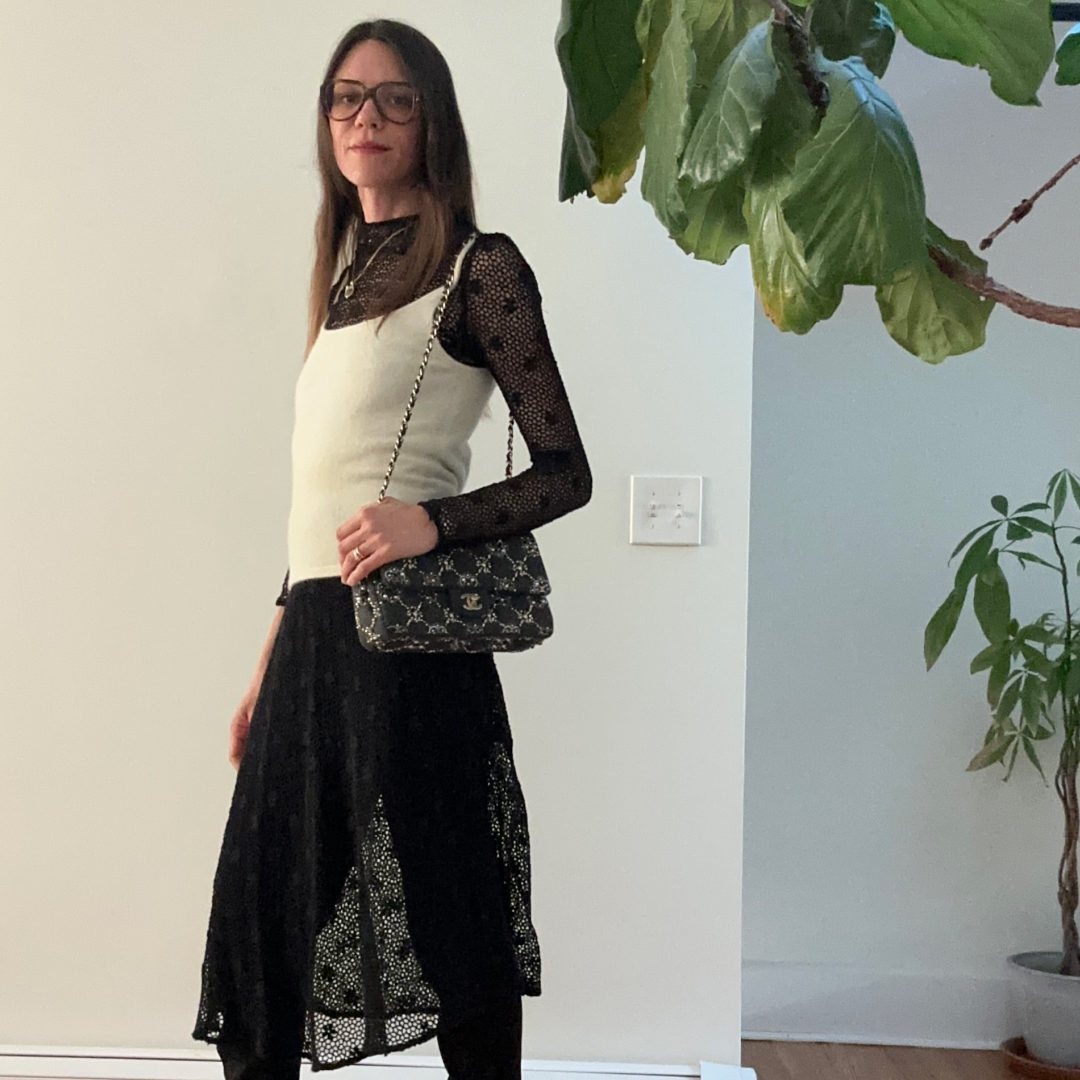 Julia Gall wearing a black sheer dress over black pants