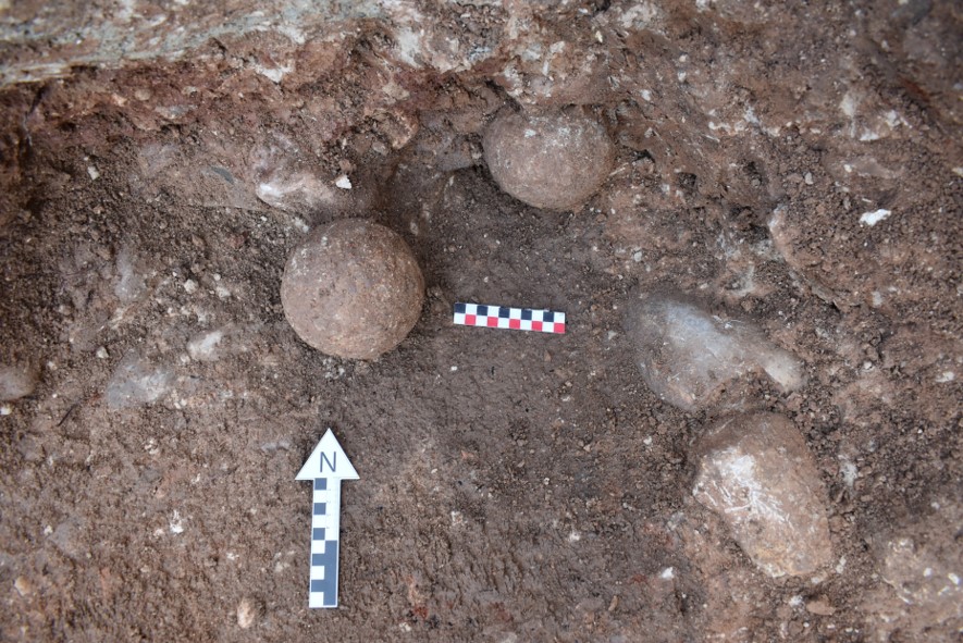 Spherical stone on the ground. Scientists think were ammunition for a Carthaginian catapult.