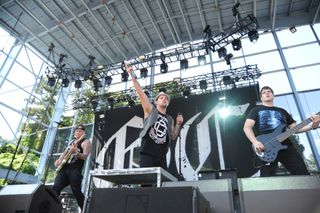 Paul Thomas (right) playing live with Good Charlotte