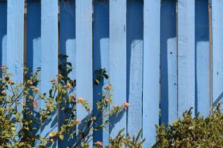 A pale blue fence
