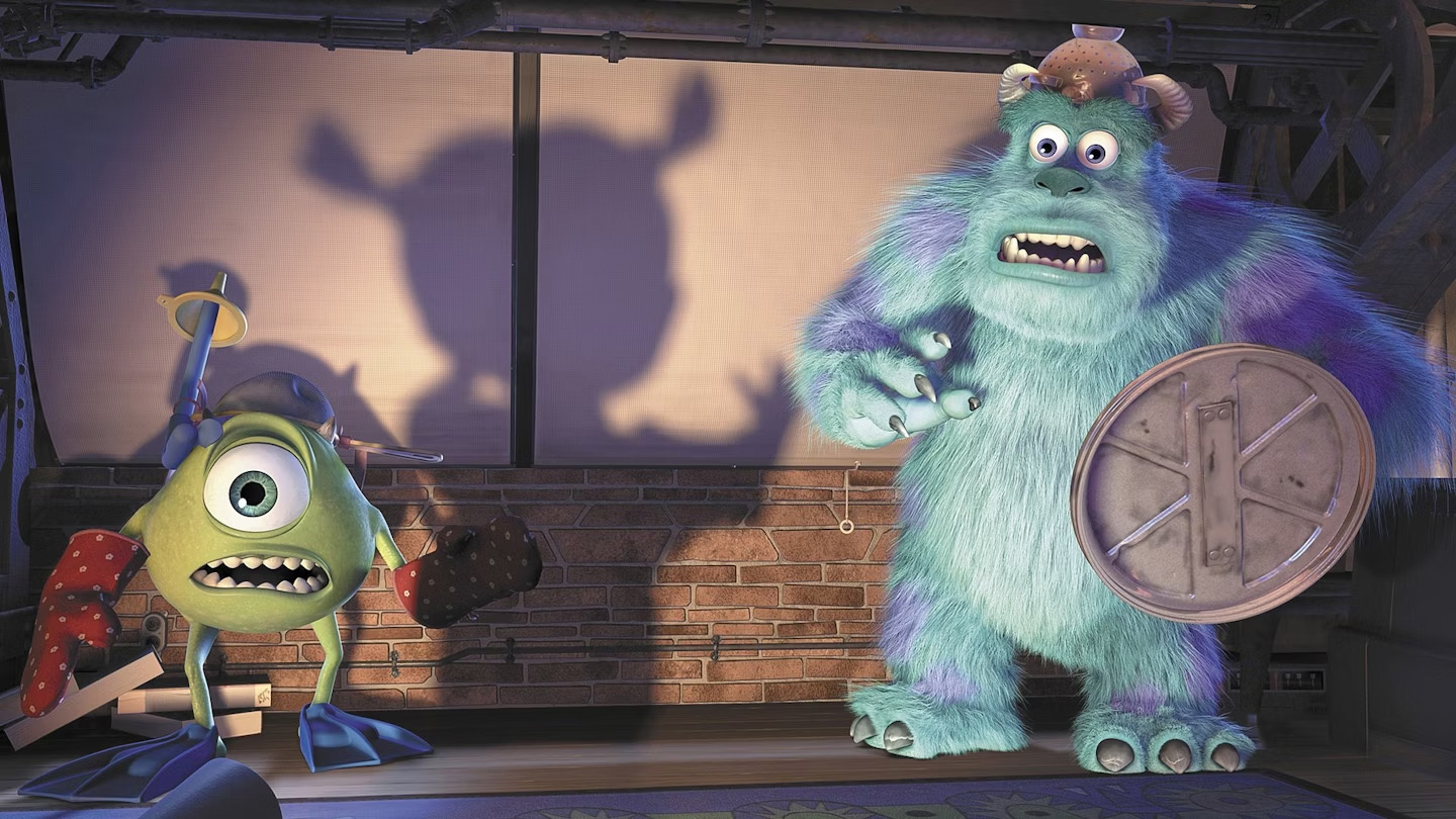 Pixar vs DreamWorks; a blue monster and a green monster on a stage, a cowboy and a space man toys