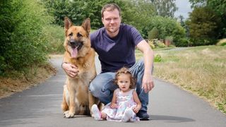 Are german shepherds good family dogs? A man and his daughter with their german shepherd