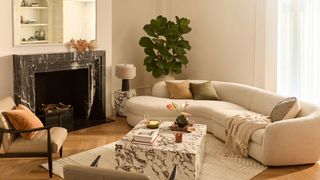 retro living room with curved cream sofa and marble coffee table