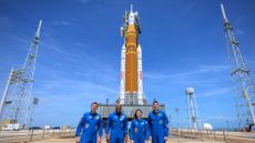 Artemis II astronauts stand before SLS rocket that will take them into space